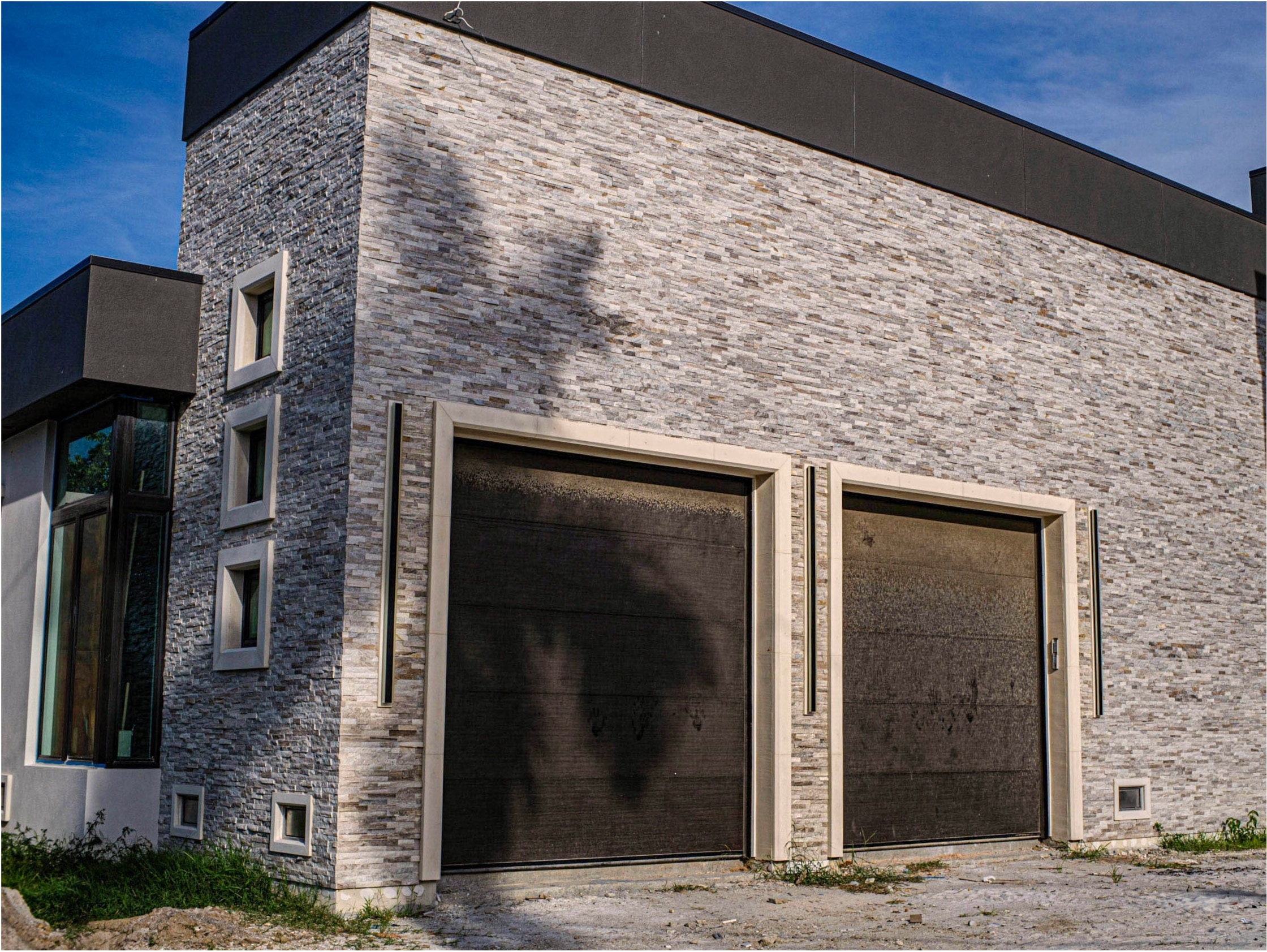 A grey-stacked modern garage — JBA stone install in the Fort Myers area